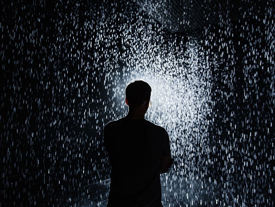 silhouette of man standing during nighttime, light, rain, droplet