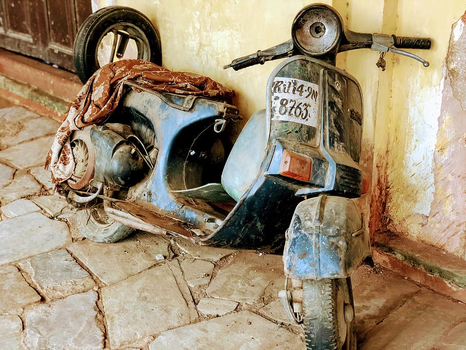 black motor scooter leaning on wall at daytime, rust, vespa, india