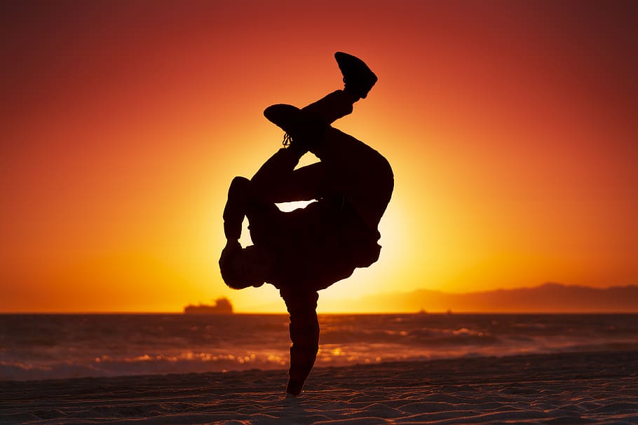silhouette of man making a handstand, united states, manhattan beach