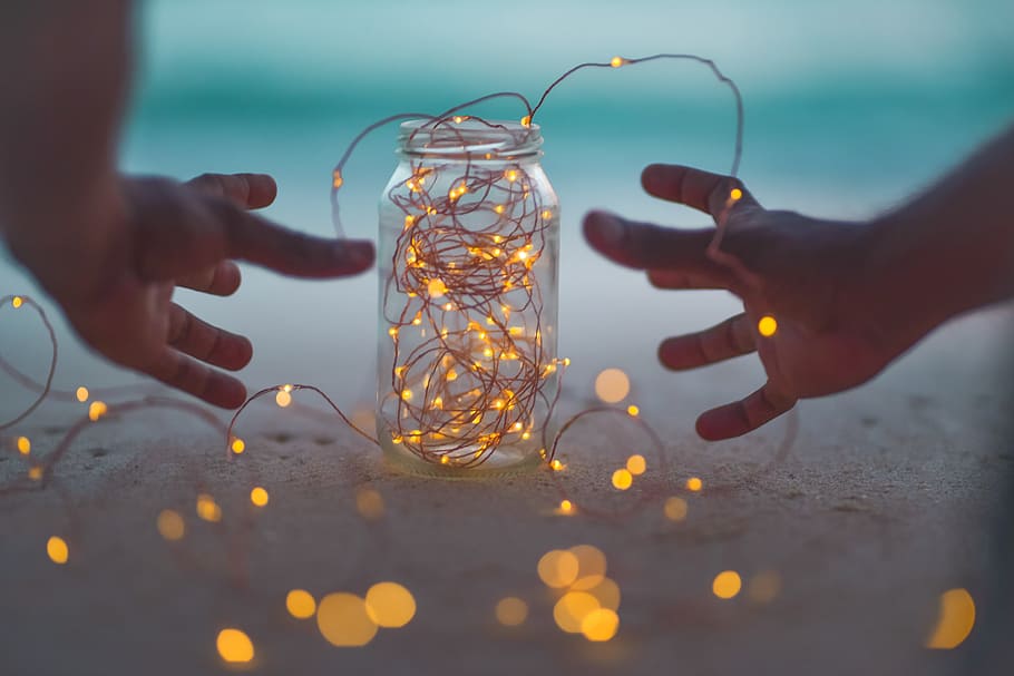 bokeh photography of lighted string lights inside Mason jar, hand HD wallpaper