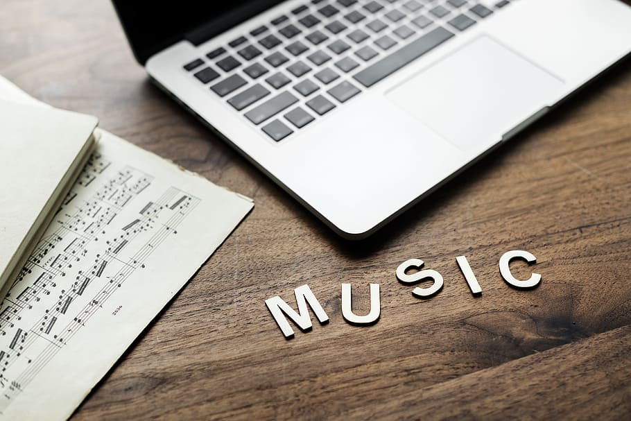 Music Cutout Letter Beside Macbook Pro on Table, background, communication