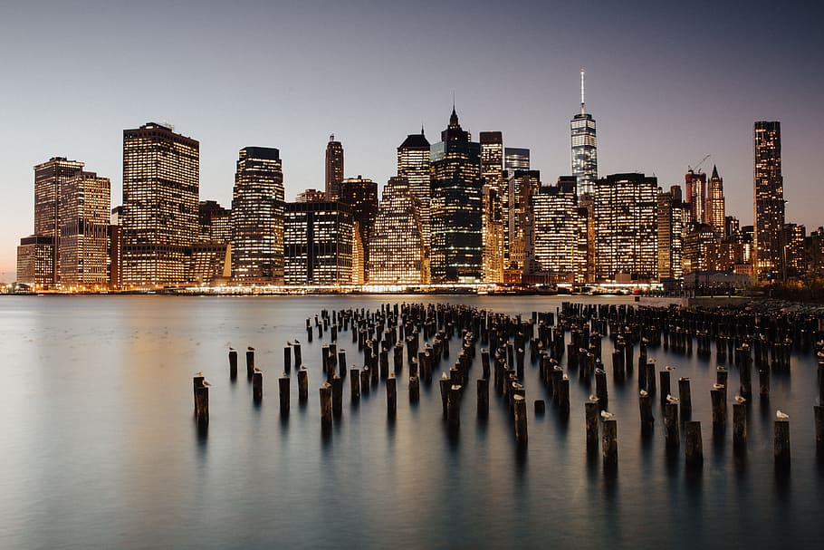 city buildings during nighttime, skyline, cityscape, ocean, skyscraper HD wallpaper