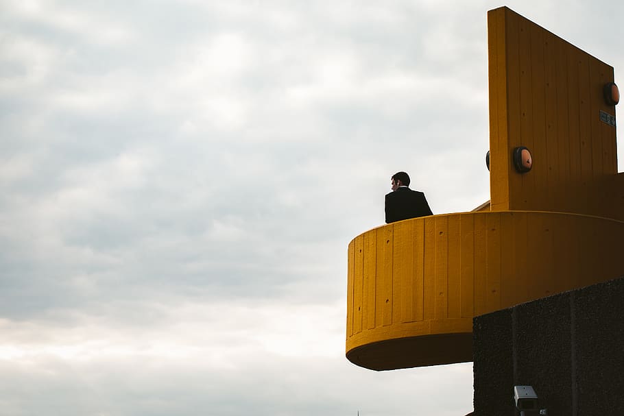 man standing on building under cloudy sky, cloud - sky, one person HD wallpaper
