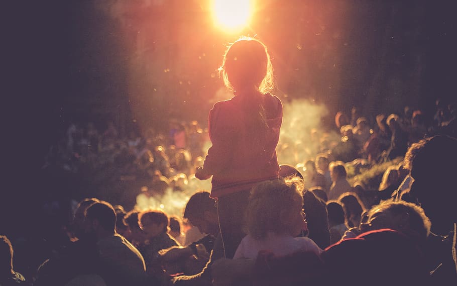 girl standing surrounded by people during nightstand, crowd, group of people