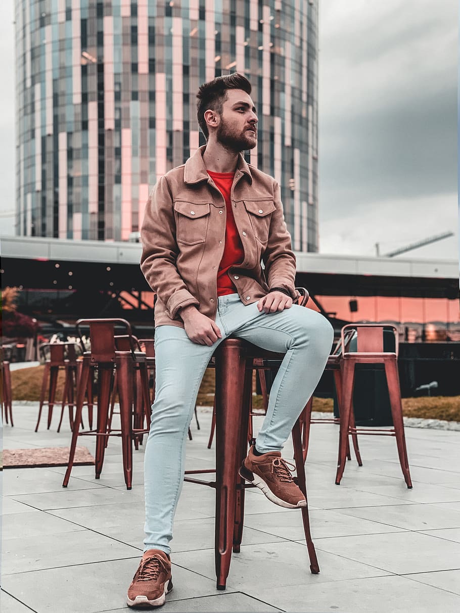 man wearing brown jacket near building, shoe, clothing, apparel