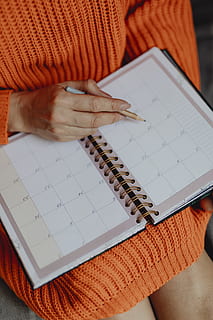 Yellow, Orange, Pink, and Blue Coloring Pens on White Notebook