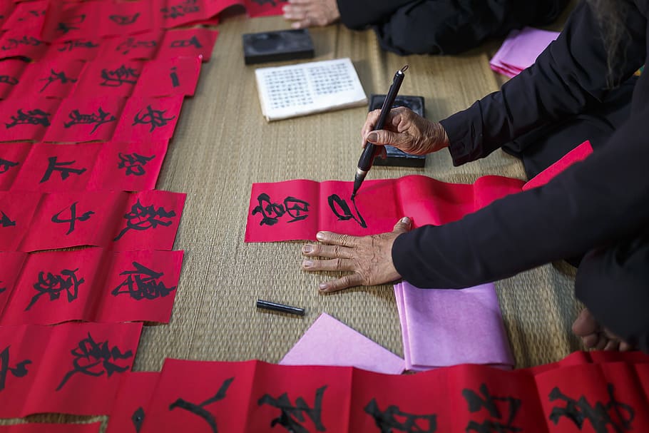 Person Writing On Red Paper, hands, text, calligraphy, human hand HD wallpaper