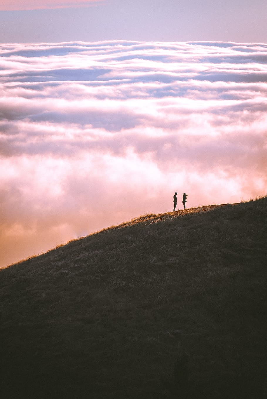 couple standing on grass field mountain, hill, cloud, together