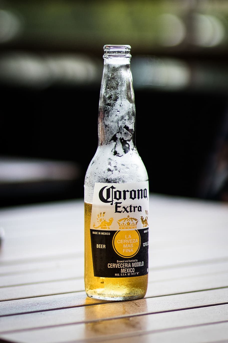 HD wallpaper: Corona Extra beer bottle on brown wooden surface during  daytime | Wallpaper Flare