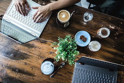 Digital nomads working in a coffeeshop, café, hands, top view HD wallpaper