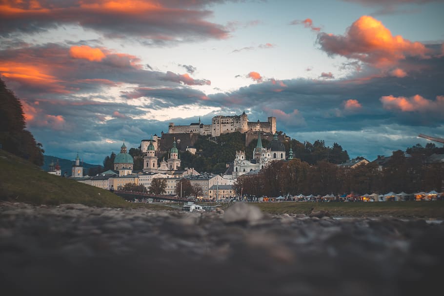 village below castle under cloudy sky during golden hour, building HD wallpaper