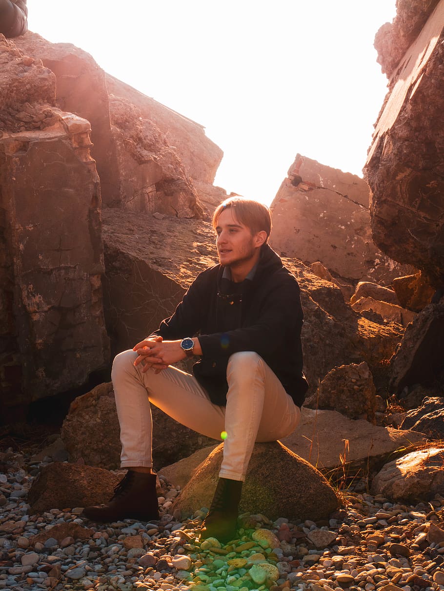 man sitting on brown stone, people, person, human, adventure HD wallpaper