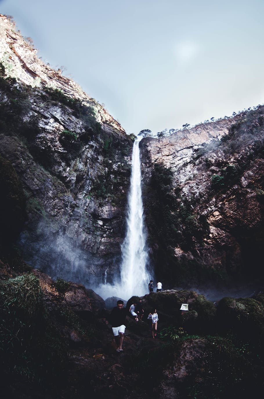 People on Brown Rock Near Waterfall, adventure, altitude, daylight HD wallpaper