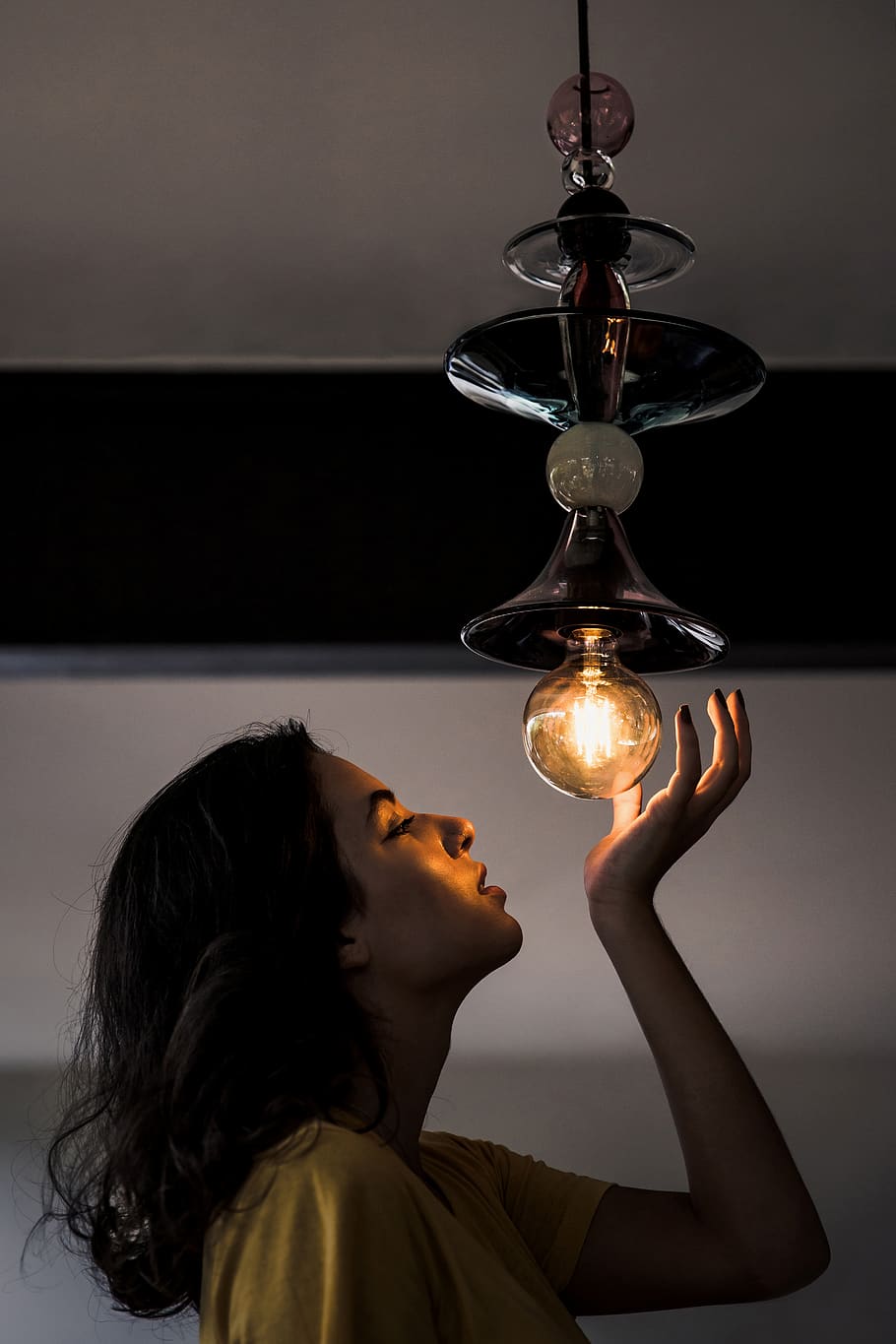Woman About To Hold A Pendant Lamp, illuminated, light, light bulb HD wallpaper