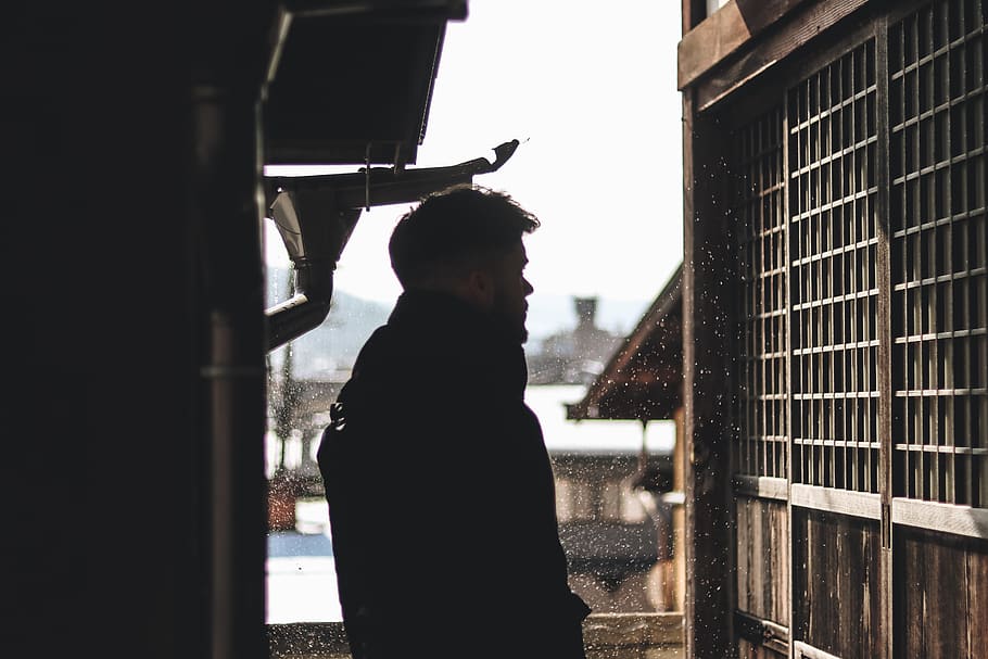 man standing under hose looking on window, one person, real people HD wallpaper