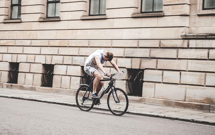 man wearing gray t-shirt and gray shorts cycling, cyclist, person