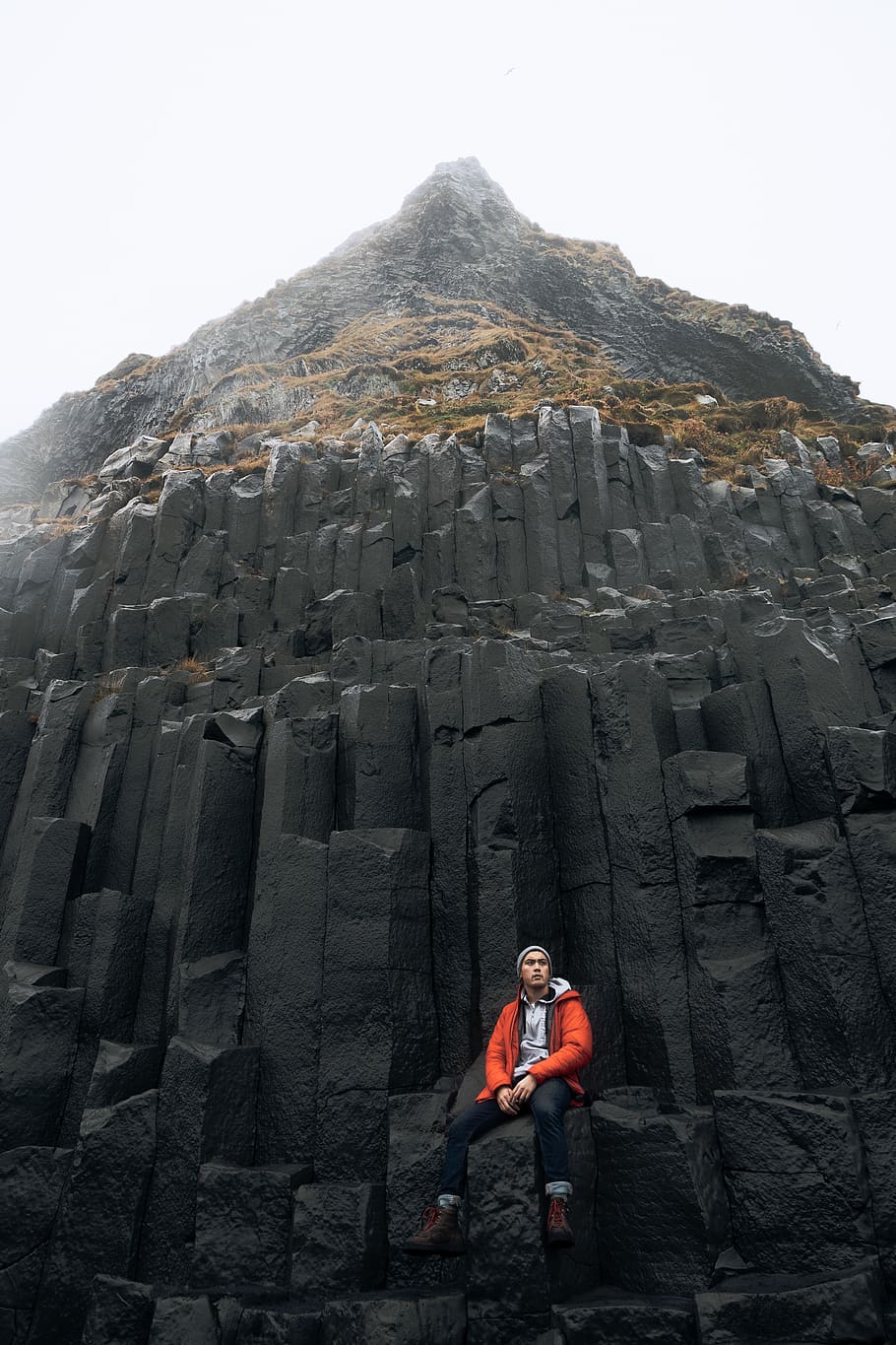 man sitting near mountain, shoe, apparel, footwear, clothing HD wallpaper