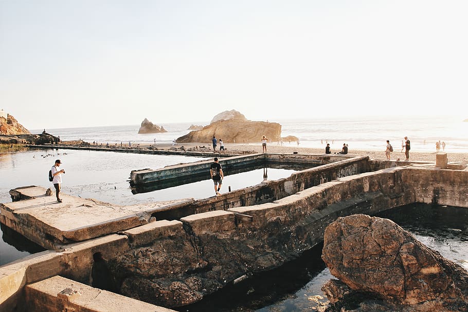 people walking on concrete pathway, water, sea, sky, solid, rock - object HD wallpaper