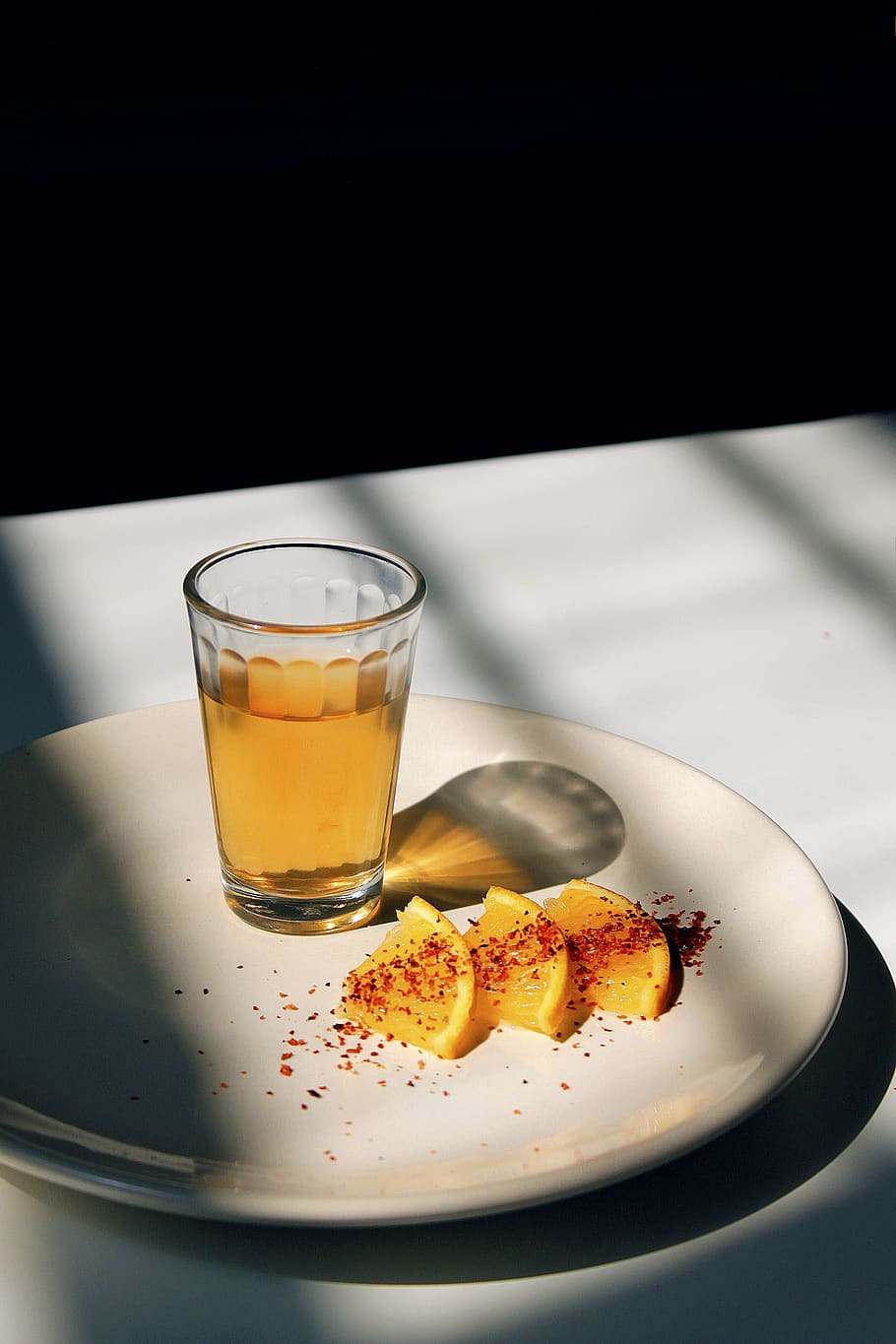 round white ceramic plate with sliced oranges, beverage, drink
