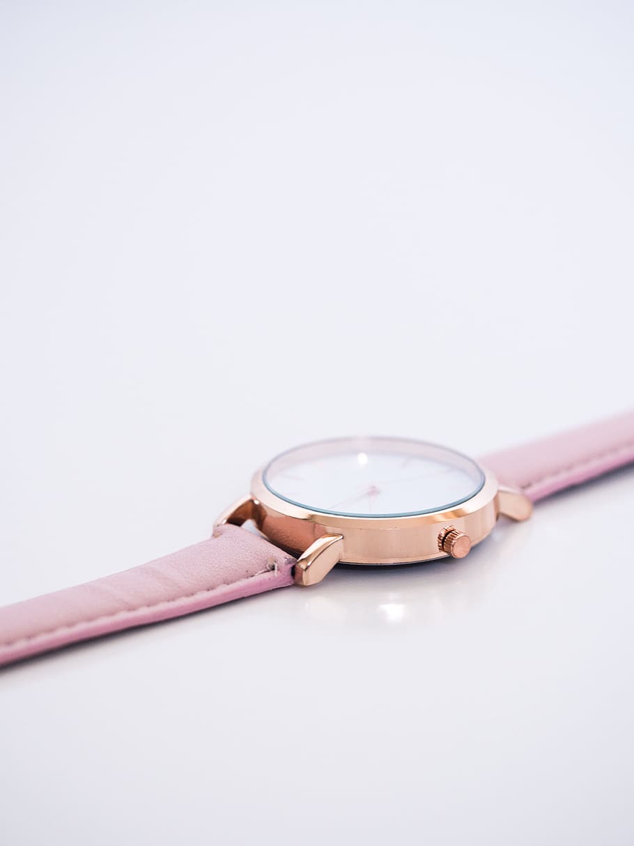 round white and gold-colored analog watch on white surface, strap HD wallpaper