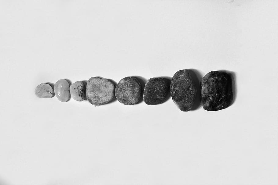 Row of Black and Gray Polished Pebble on Gray Surface, close-up HD wallpaper
