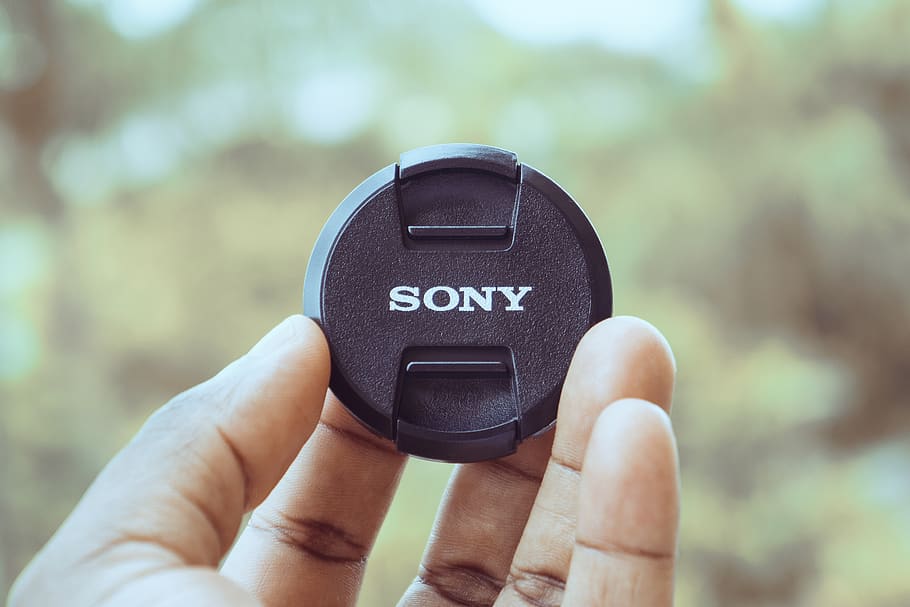 black Sony lens cap, person, human, wristwatch, finger, hand HD wallpaper