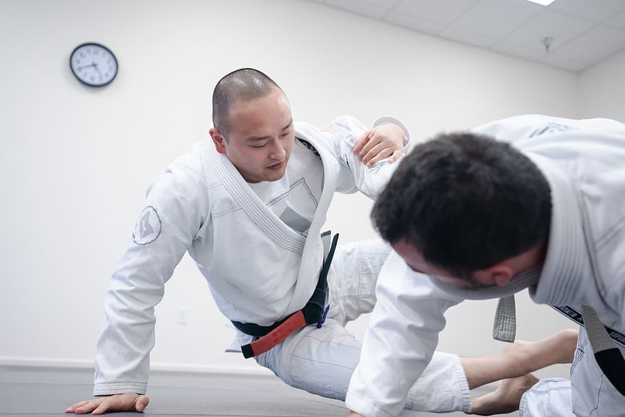 two men doing karate inside room, person, human, sports, judo