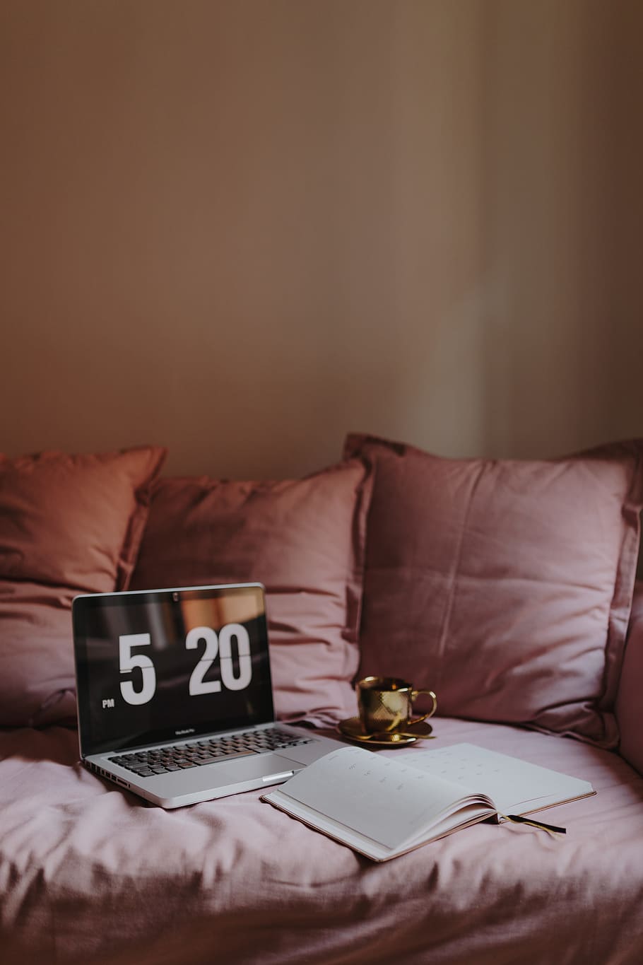 Workplace with a laptop on a pink couch, macbook, macbook pro HD wallpaper