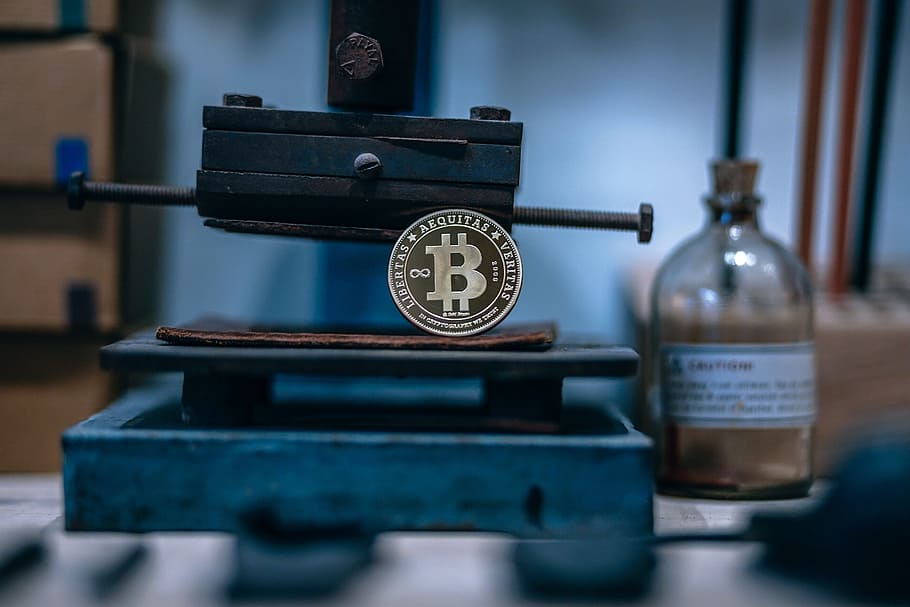Gold Plated Bitcoin Placed on a Rusty Machine With Blur Background HD wallpaper