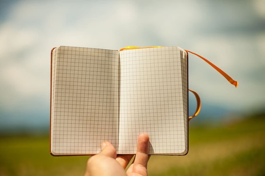Person Holding Graphing Book, checked, hand, notebook, notepad HD wallpaper