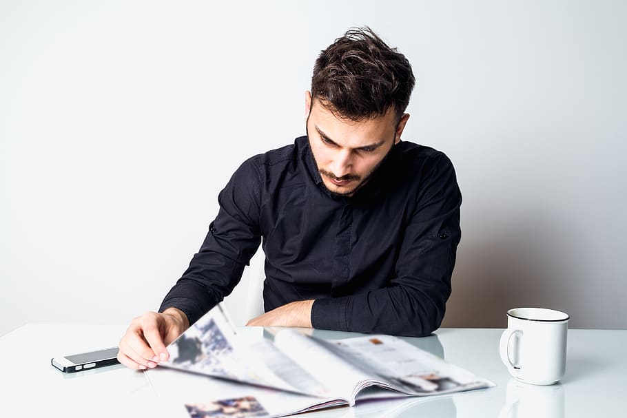 man reasing magazine, one person, young men, young adult, studio shot HD wallpaper