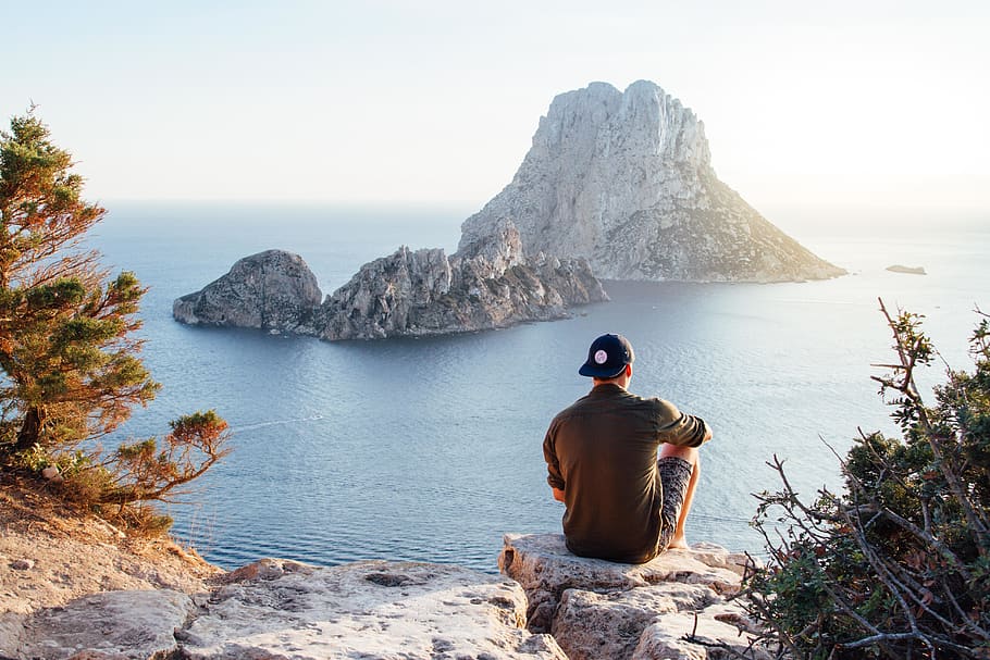 Rear View of Man Sitting on Rock by Sea, adventure, bay, beach, HD wallpaper