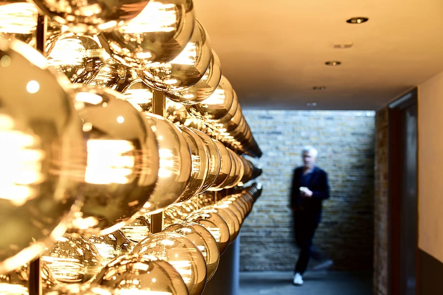 Man Passing Near Brown Brick Wall, ceiling, colors, design, display HD wallpaper