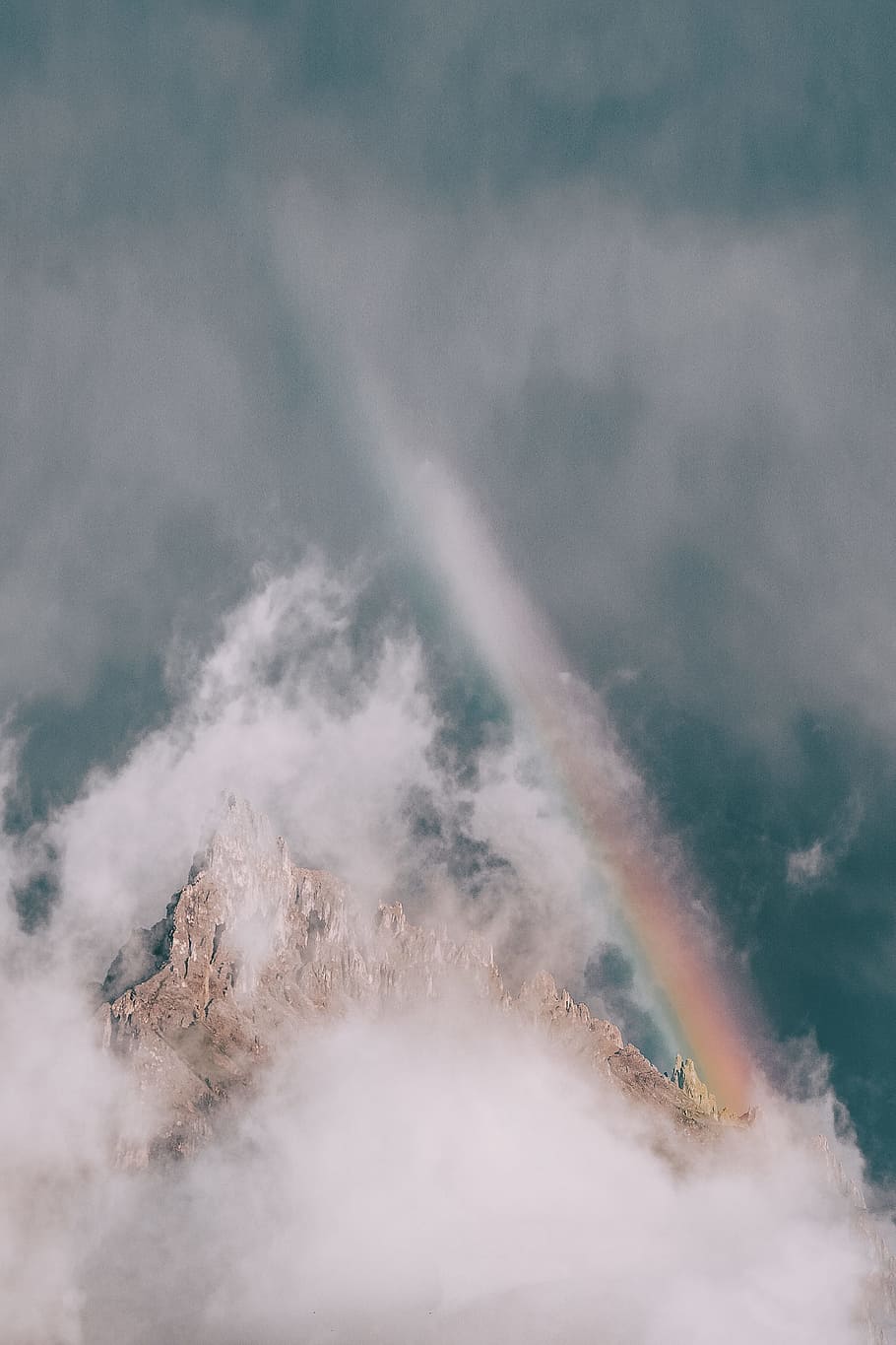 rock mountain covered in fog with rainbow, drone view, aerial view HD wallpaper