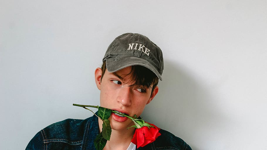 man biting red rose, portrait, headshot, one person, clothing HD wallpaper