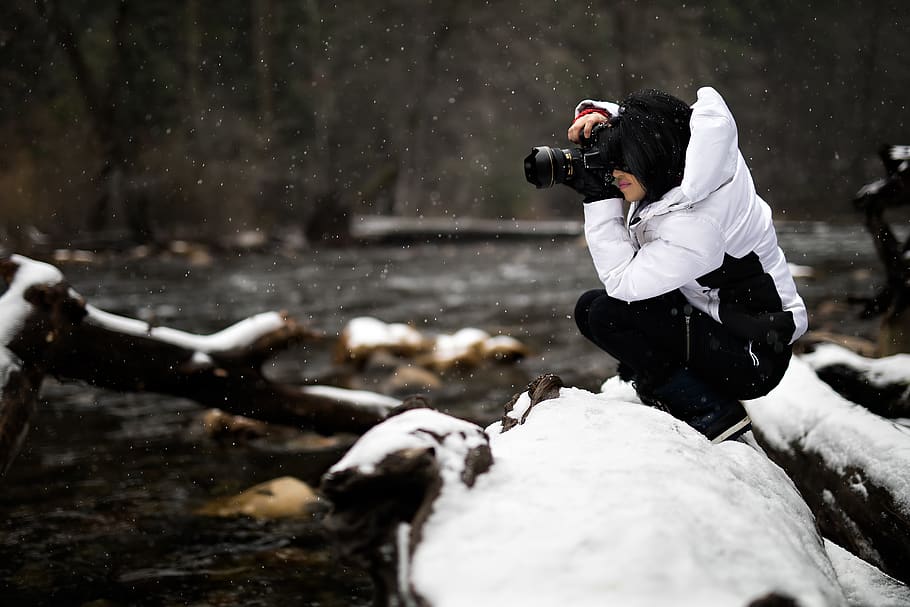 person holding camera on snow-covered surface, human, photographer