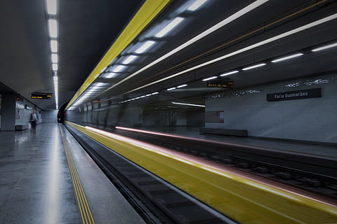 person standing near the train rails inside the tunnel, platform HD wallpaper