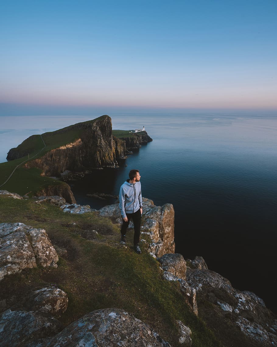 Man Standing on Green and Gray Mountain, cliff, coast, daylight HD wallpaper