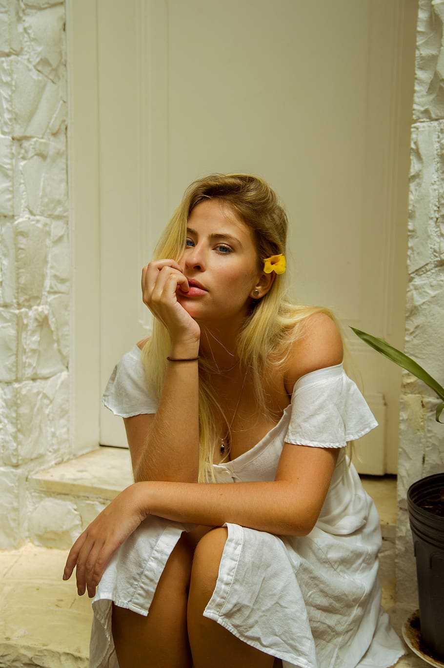 Woman in White Dress Sitting Near Closed Door, attractive, beautiful