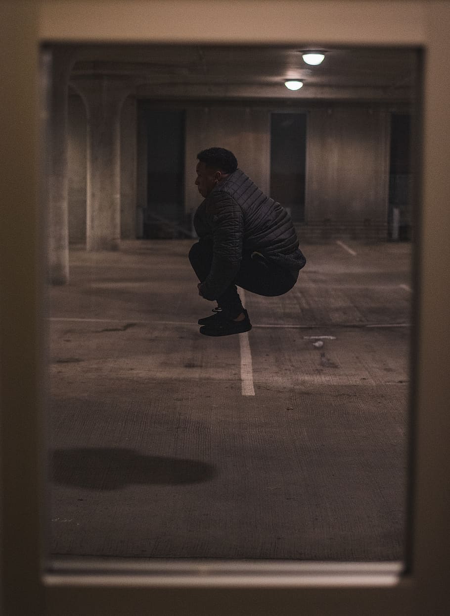 man in black jacket jumping, corridor, footwear, apparel, shoe HD wallpaper