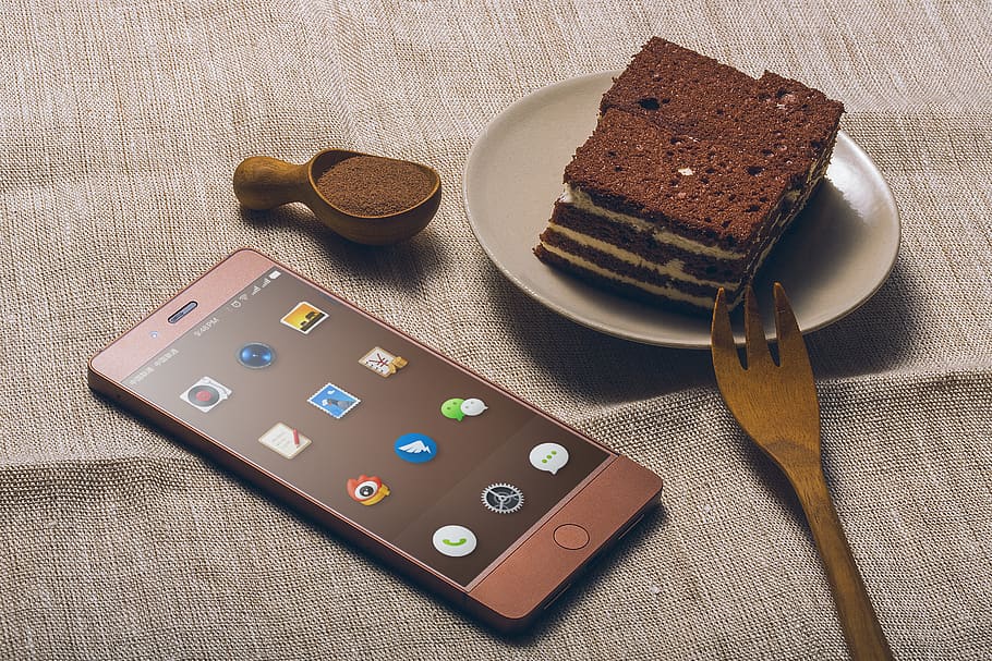 Chocolate Cake on Saucer Beside Iphone, baking, candy, cell phone HD wallpaper