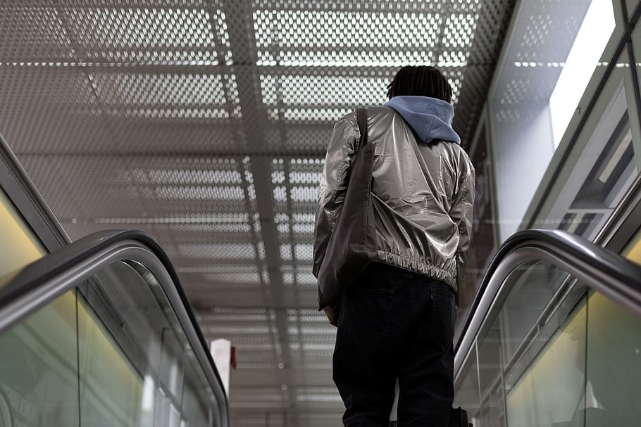man standing on escalator, clothing, apparel, jacket, coat, person HD wallpaper