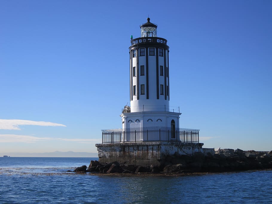 lighthouse, beacon, rocks, rocky, shore, water, architecture HD wallpaper
