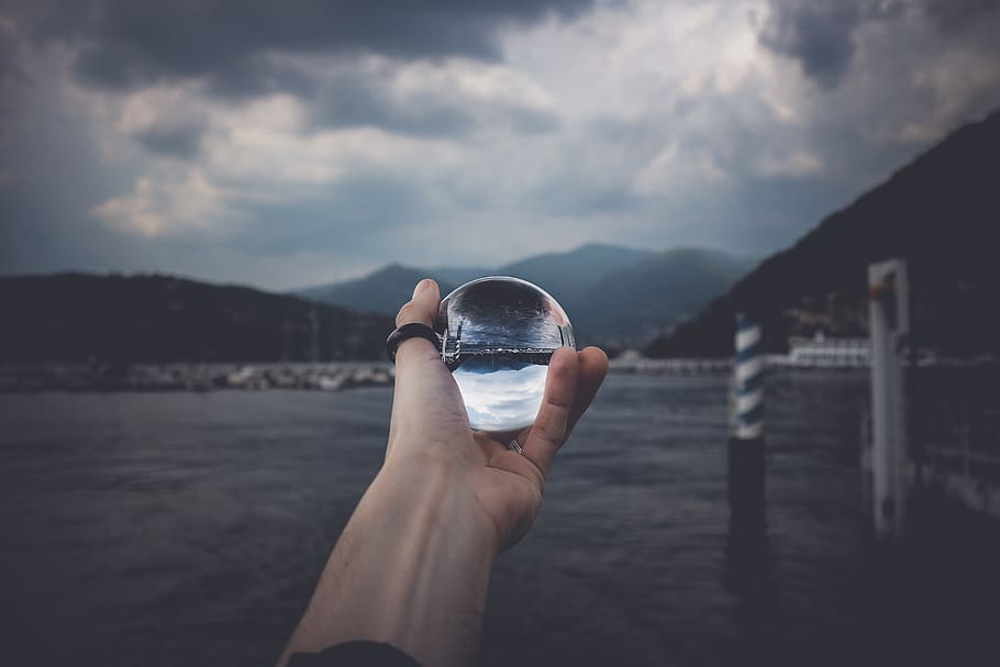 Person Holding Water Orb, bay, clouds, crystal ball, daylight HD wallpaper
