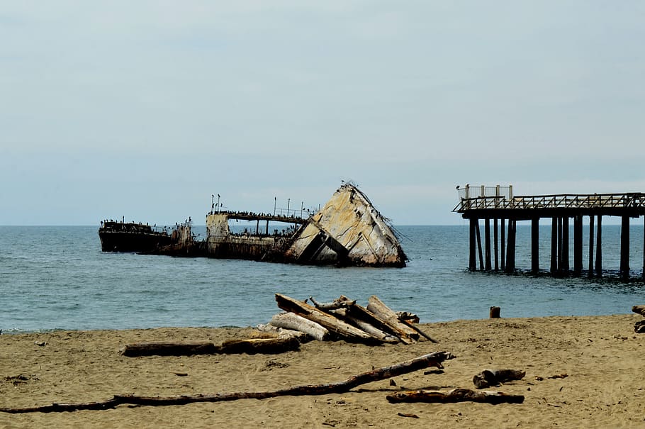 ship, sunken, concrete, pier, ocean, boat, logs, driftwood HD wallpaper