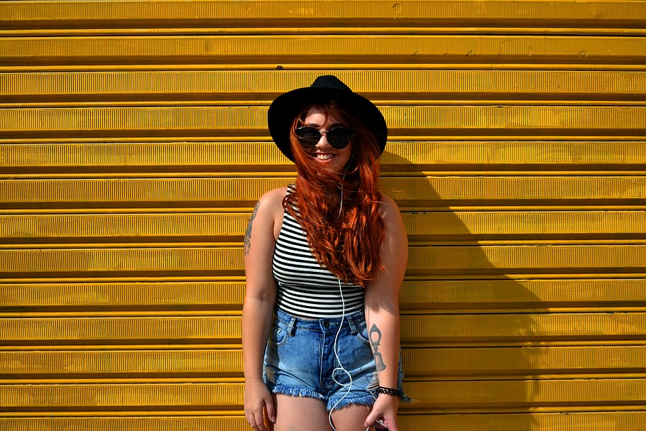 A redhead woman standing in front of a yellow wall., brazil, são paulo