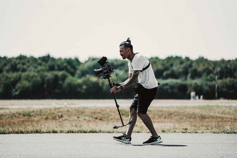 man holding camera doing shoot, human, person, apparel, clothing HD wallpaper