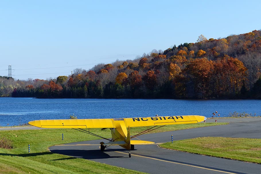 A Piper Cub single engine private airplane taxiing to ready for a takepoff from a local airport.