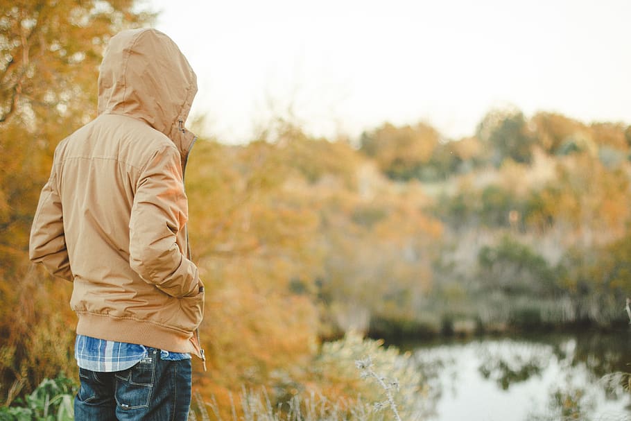 Selective Focus Photography of Person Standing While Facing Body of Water HD wallpaper