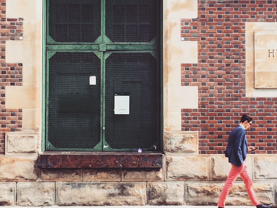 Man Walking On Sidewalk, architecture, brick wall, building, person HD wallpaper